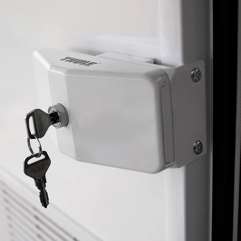 A key is inside a Thule Door Frame Lock caravan lock.