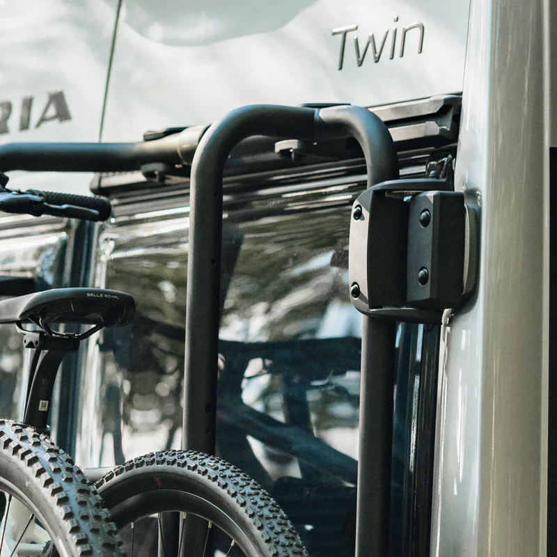 A close-up of the Thule Mounting Frame securely attached to the rear of a camper van, holding two bikes in place. The durable frame ensures a strong and stable fit for bike transportation.