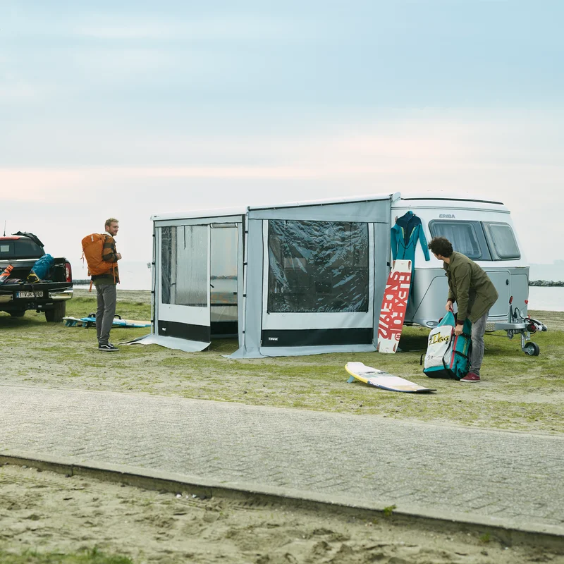 A van parked by a street with a Thule Residence G3 Eriba van awning tent.
