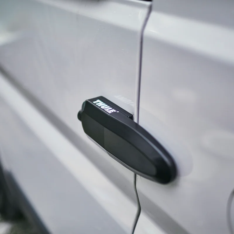 A person unlocks a caravan using the Thule Universal Lock caravan lock.