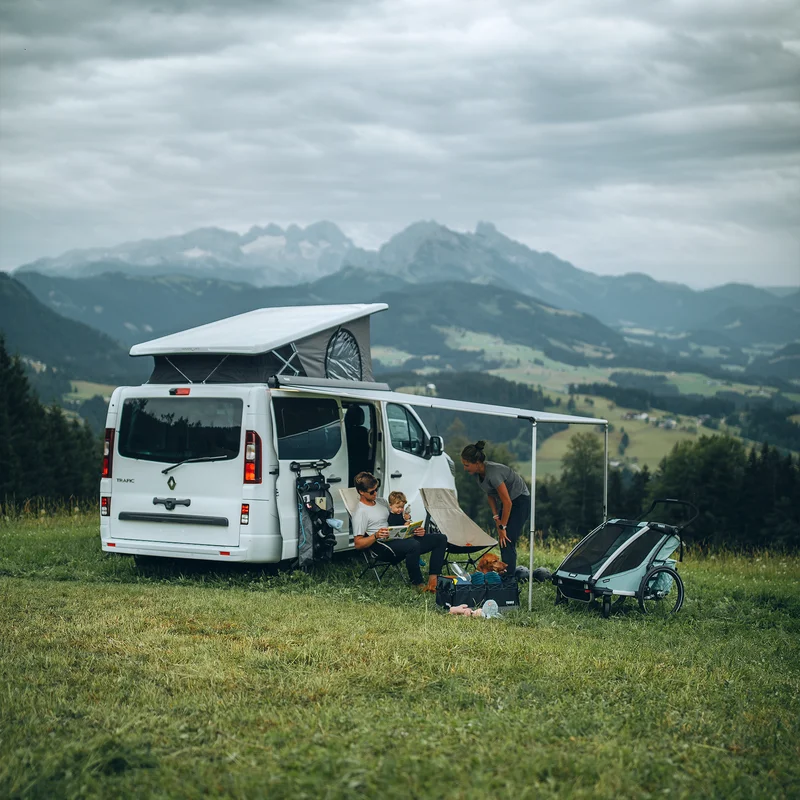 A van is parked looking at a mountain with a Thule Wall Organizer attached to the wall.