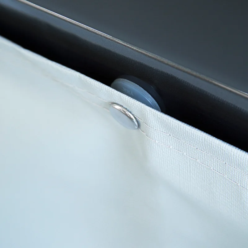 A close-up of someone placing a white Thule Wheelcover on an RV.